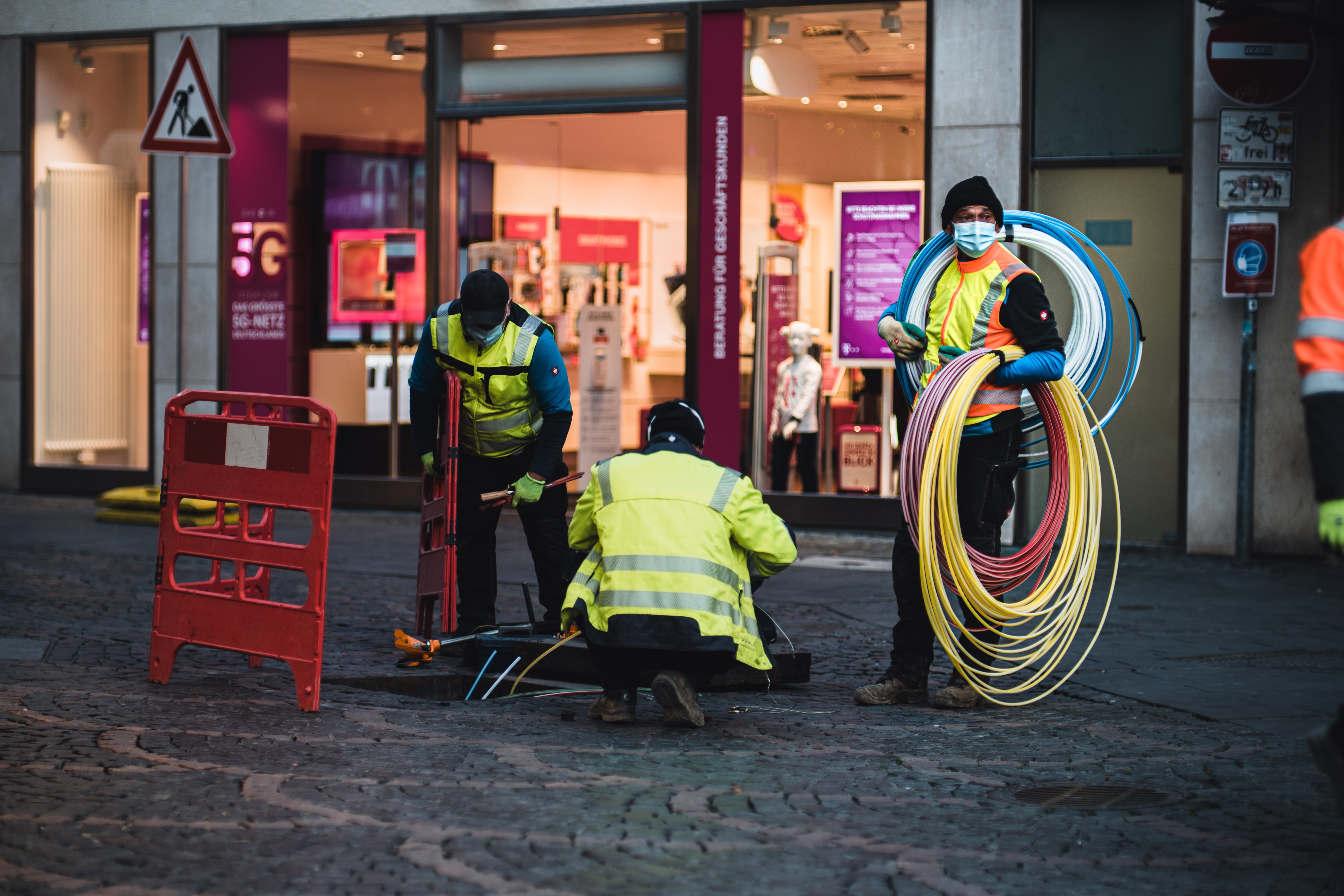 Technicians installing empty pipes for fast fiber internet across the city